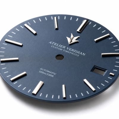 Applied metal logo badge on dial