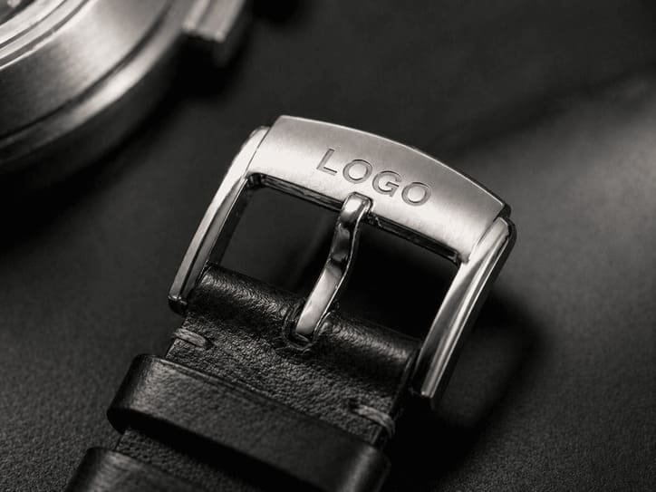 Custom buckle branding example showing logo engraved on metal clasp