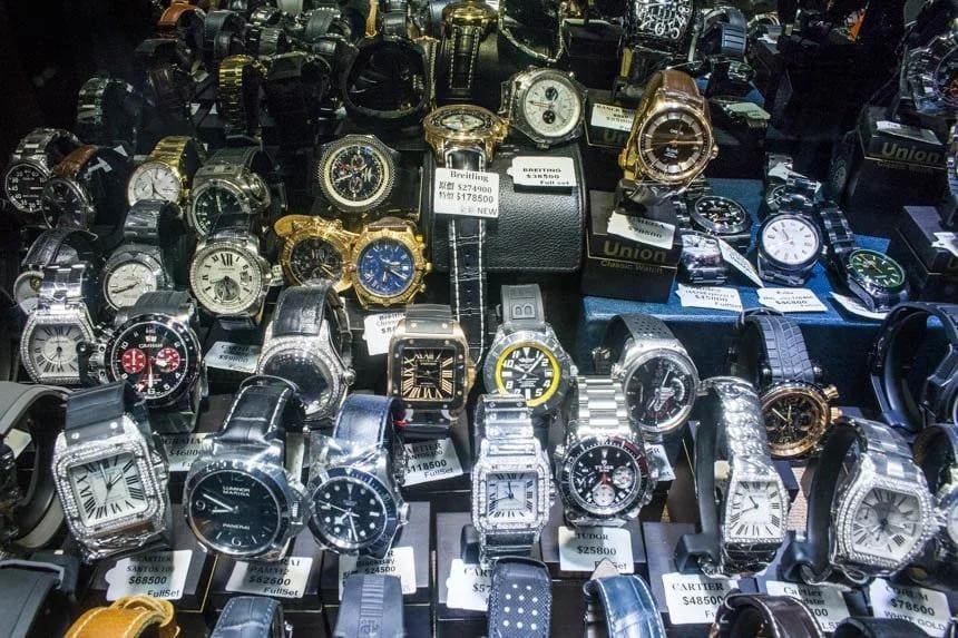 Close-up of replica watches in a display case