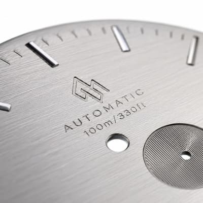 Laser engraved logo on dial