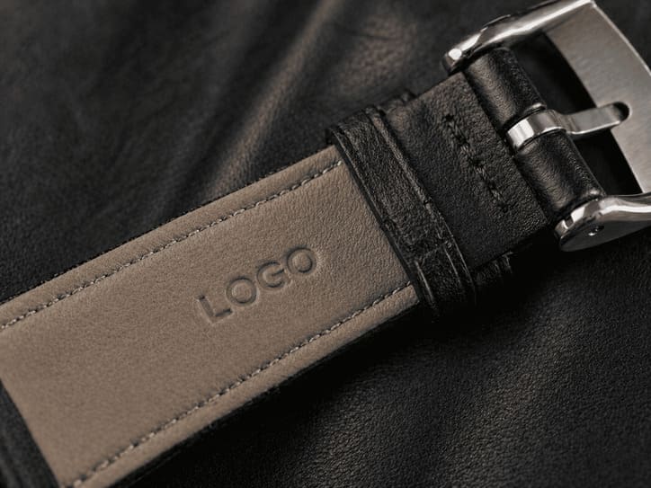 Strap branding example showing embossed logo on leather watch strap