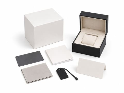 Packaging accessories including warranty cards, polishing cloth and instruction booklets
