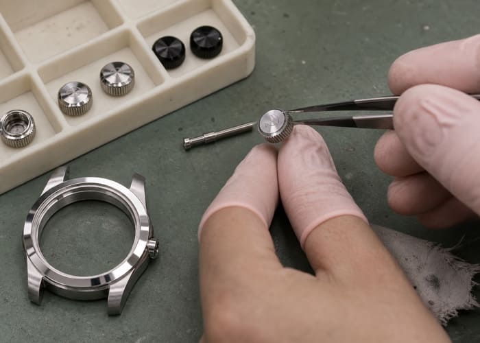 A close-up of a custom-designed watch crown with an engraved logo, highlighting the OEM watch crown development process.
