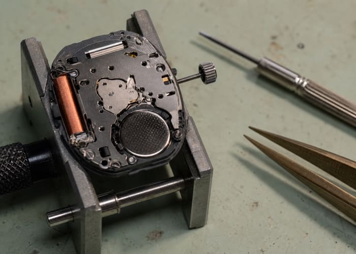 A close-up of a Japanese Miyota quartz movement, a key factor in quartz watch manufacturing cost.