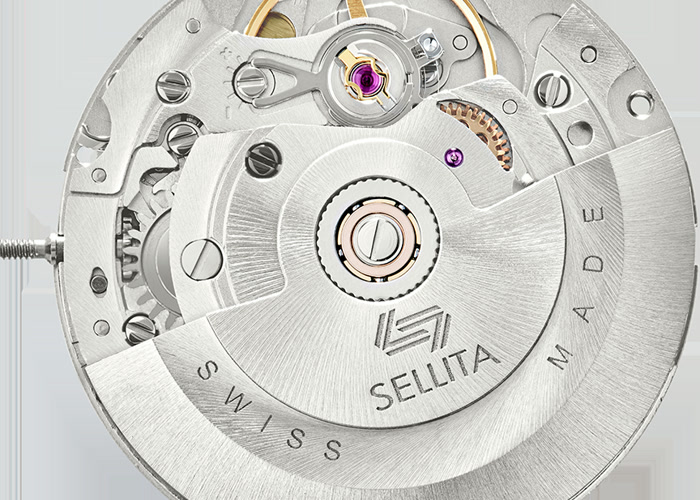 a close-up of a watch movement with gears and jewels visible